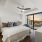 large bedroom with floor-to-ceiling window offering downtown views