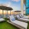 umbrella shaded lounge chairs on pool deck